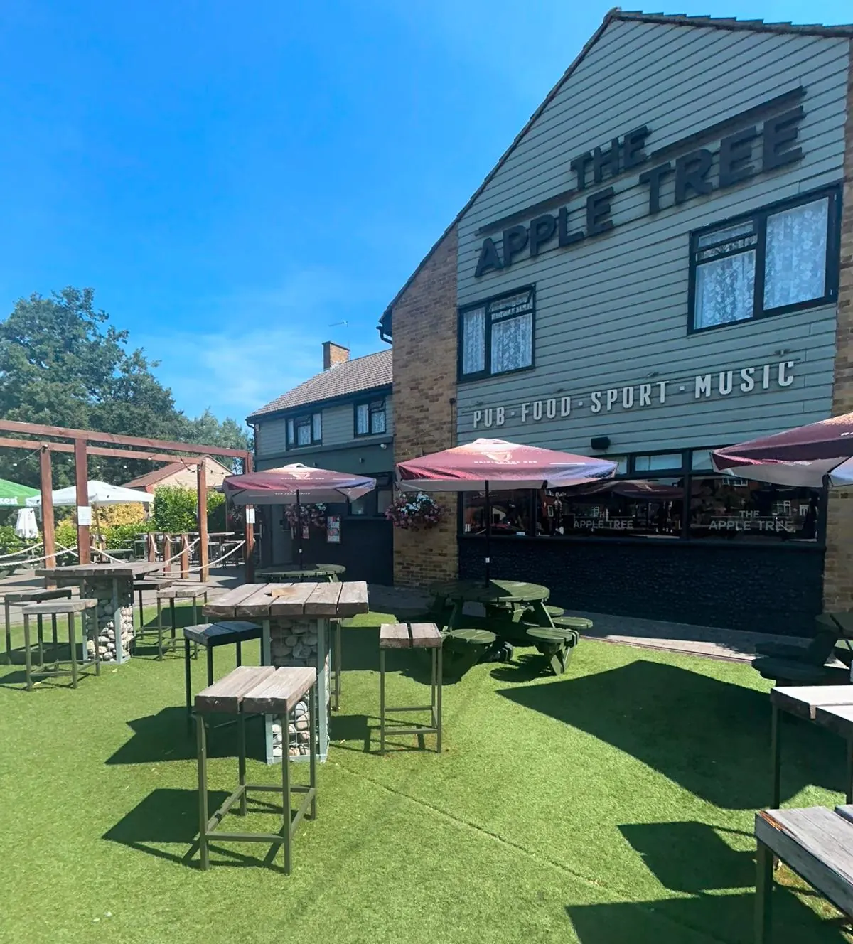 Tall tables on the lawn in front of the pub