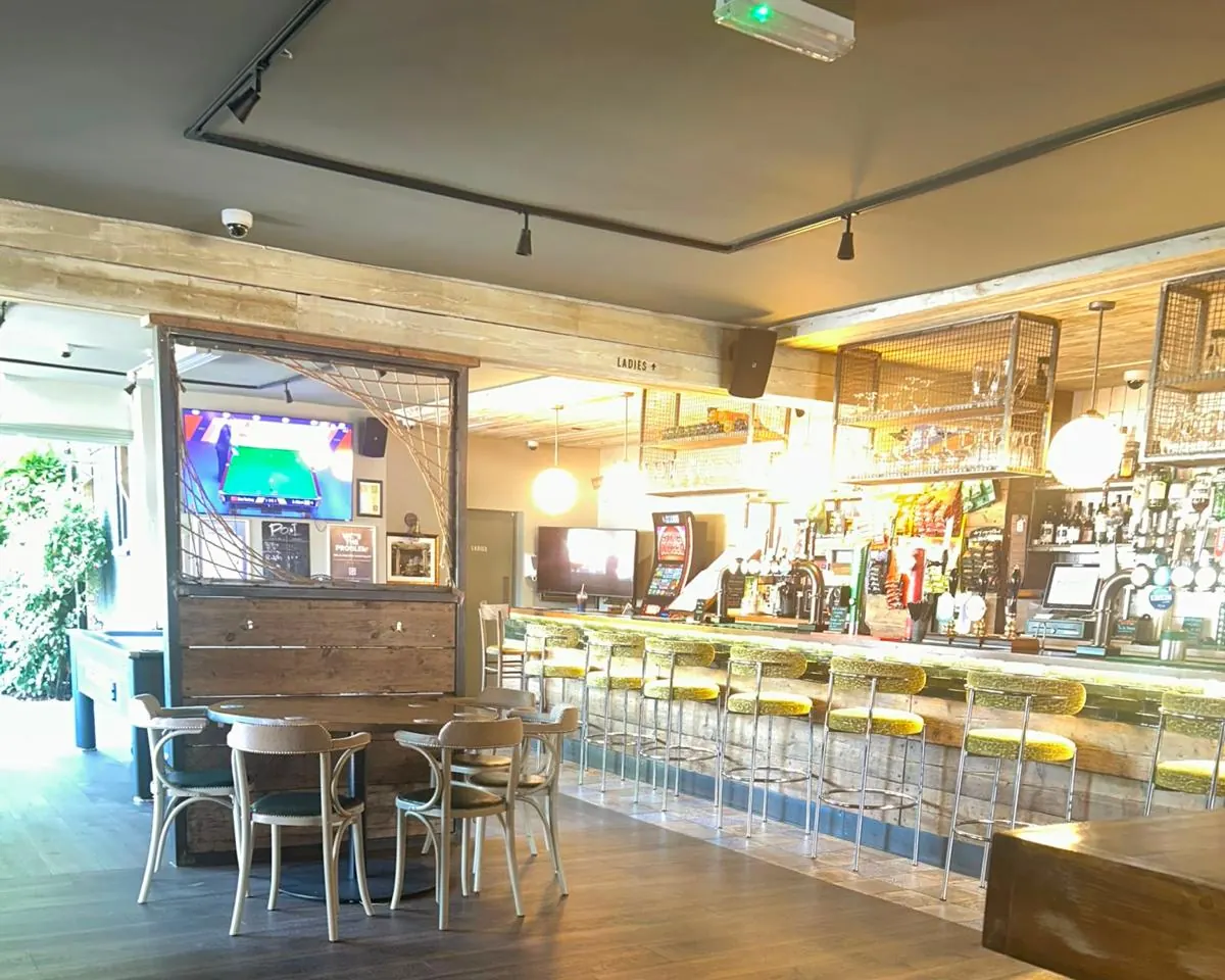 The long bar, with a screen showing football at the far end